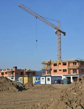 Two buildings in process of construction with tower crane behind them Stock Photos