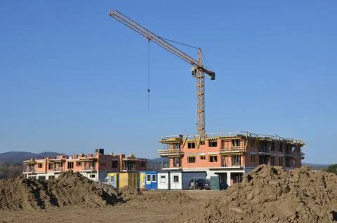 Two buildings in process of construction with tower crane behind them Stock Photos