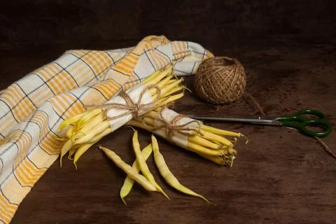 Two bunch and several pods of flat runner bean pods heap with yellow kitche.. Stock Photos
