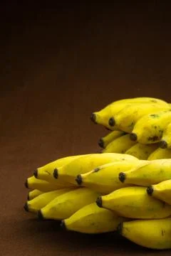 Two bunches of banana fruit on a matte background Stock Photos