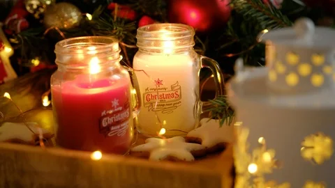 Two burning candles in beautiful decorative Christmas jars Stock Footage 116759355