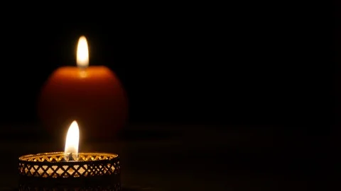 Two burning candles on a black background in the left part of the frame Stock-Footage 122211439