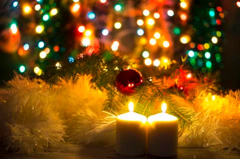 Two burning candles on a blurred background Stock Photos