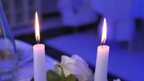 Two burning candles on a decorated banquet table with blue light Vídeo Stock 345115290