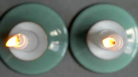 Two burning candles in holders. Stock Footage 221234054
