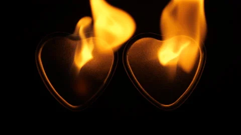 Two burning hearts in flame on black background. Fire hearts concept Stock Footage 144846380