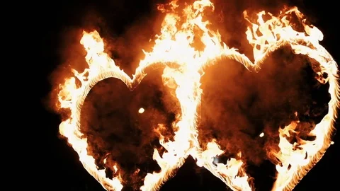 Two burning hearts on wedding fireshow. Slow motion. Two burning hearts on weddi Stock Footage 128758795