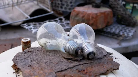 Two Burnt Light Bulbs on Rusty Metal Stock Footage 293194568