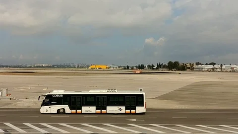 Two buses passing and and airplane goes dowon in airport Stock Footage 100366521
