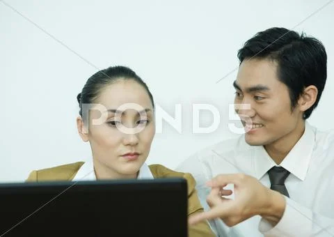Two Business Associates Using Computer, Man Pointing Toward Screen