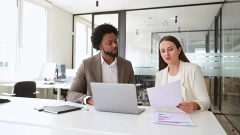 Two business colleagues engaging in a constructive discussion with a focus on Video stock 276897318
