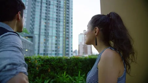 Two business executives interacting with each other in office balcony Stock Footage 75450628