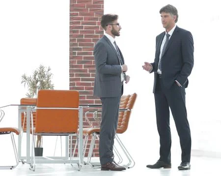Two business executives talking about business in the office. Stock Photos