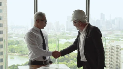 Two business man shaking hands each other over window on cityscape background Stock Footage 158468134