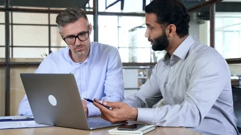 Two business men analysts discussing data management using laptop computer. Stock Footage 164101846