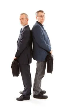 Two business men back to back with laptop bags Stock Photos