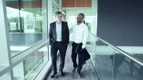 Two Business men discussing while walking in office corridor Vídeo Stock 59398616
