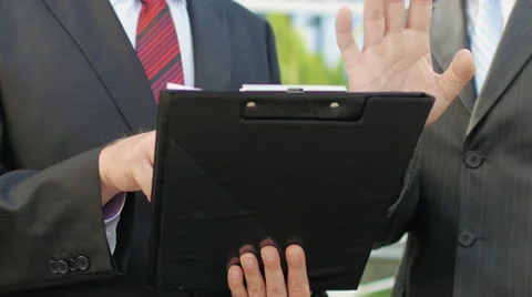 Two business men standing next to an office building to discuss the case Stock Footage 52820758