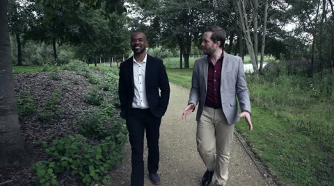 Two Business men walking on a lawn Stock Footage 59402618