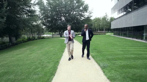Two Business men walking in lawn Stock Footage 59402701