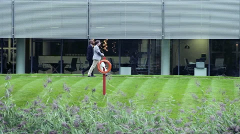 Two Business men walking near office building Stock Footage 59397830