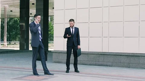 Two business men working outdoors at the middle of working day Stock-Footage 68971908