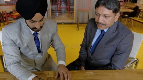 Two business men working on a touch screen tablet communication electronic devic Stock Footage 102548098