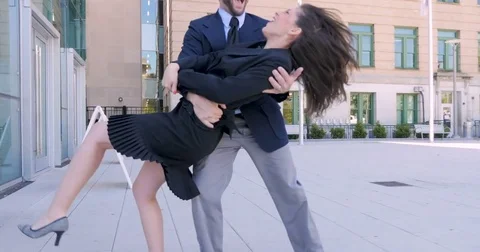 Two business partners high five and dancing outside office building in 4k Stock Footage 78510137