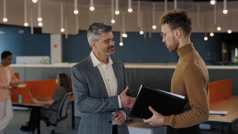 Two Business Partners Holding Folder with Documents Communicate Before Meeting Stock Footage 240272851