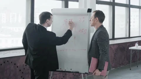 Two business partners make calculations for the project in the office near the Stock Footage 134158035