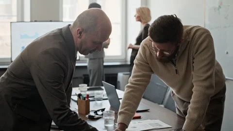 Two Business Partners Reading Documents and Shaking Hands in Meeting Room Stock Footage 333753407