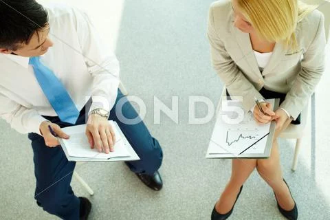 Two business partners sitting and planning work Stock Photos