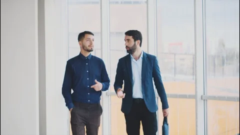 Two business partners talk thinking about a new contract. Stock Footage 102391922