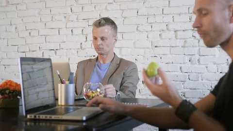 Two business people in the creative office work with laptops and throw colored Stock Footage 91599036