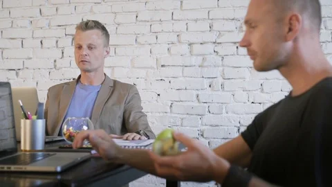 Two business people in the creative office work with laptops and throw colored Stock Footage 91600060