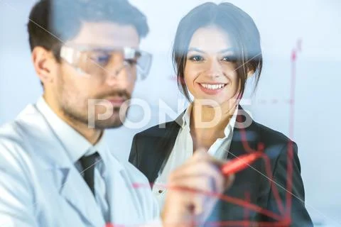 The two business people draw the graph at the virtual screen Stock Photos