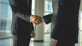 The two business people handshake in the office hall. slow motion 4k or 4k+ Resolution