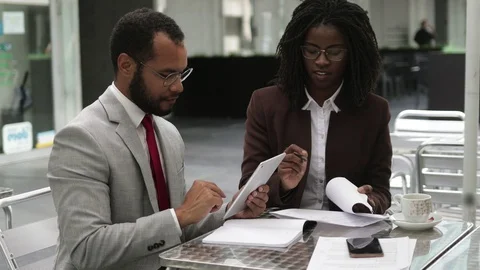 Two business people signing documents at cafe Video stock 114963953
