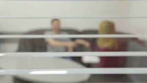 Two business people at table talks, intentionally defocused image Stock Footage 74083244
