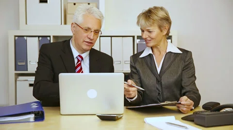 Two business people talking in office Stock Footage 34624013