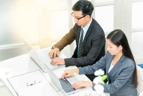 Two business people working on computer Stock Photos
