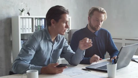 Two business persons are work together in modern office. Team of businessmen are Stock Footage 142306936
