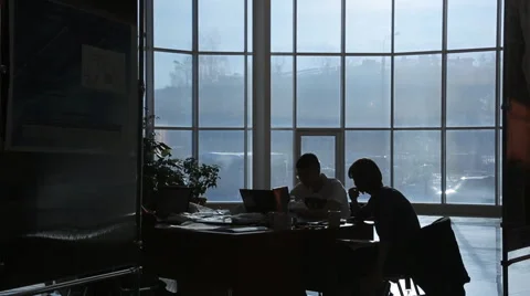 Two business persons work in dark office in evening Stock Footage 64302532
