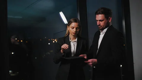 Two business professionals are seen working together in a modern office setting Stock Footage 283967249