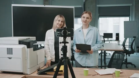 Two business professionals converse about project documents in a dynamic office Video stock 310557466