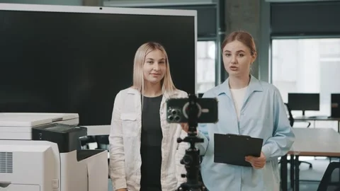 Two business professionals converse about their project in a contemporary office 스톡 동영상 310557498
