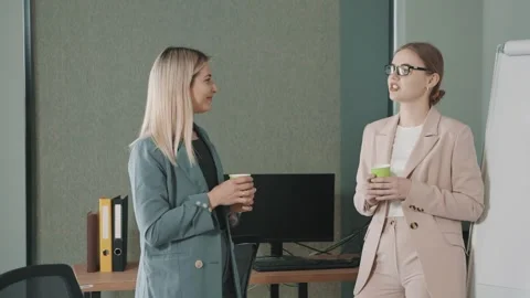 Two business professionals engage in a discussion about an ongoing project Video stock 310555973
