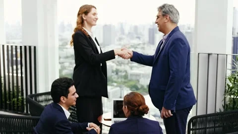 Two business professionals shake hands outdoors on a rooftop. Stock Footage 315016671