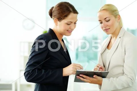 Two business women planning work Stock Photos