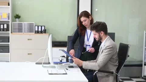 Two business workers talking on the smartphone and using laptop Video stock 312981678